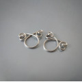 Handmade silver non-piercing nipple rings with elegant loop and swirl design. Adjustable fit, comfortable wear, sold as a matching pair